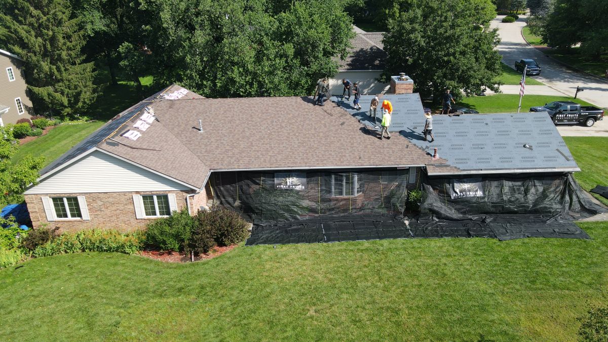 Residential roof getting a new roof by First Fruits Construction