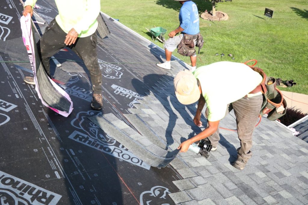 First Fruits team installing Owens Corning shingles on a roof
