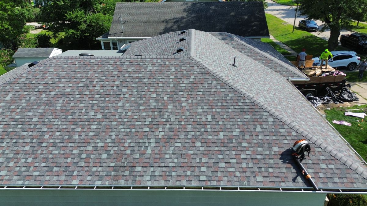Close-up of a newly installed, dark grey asphalt shingle roof